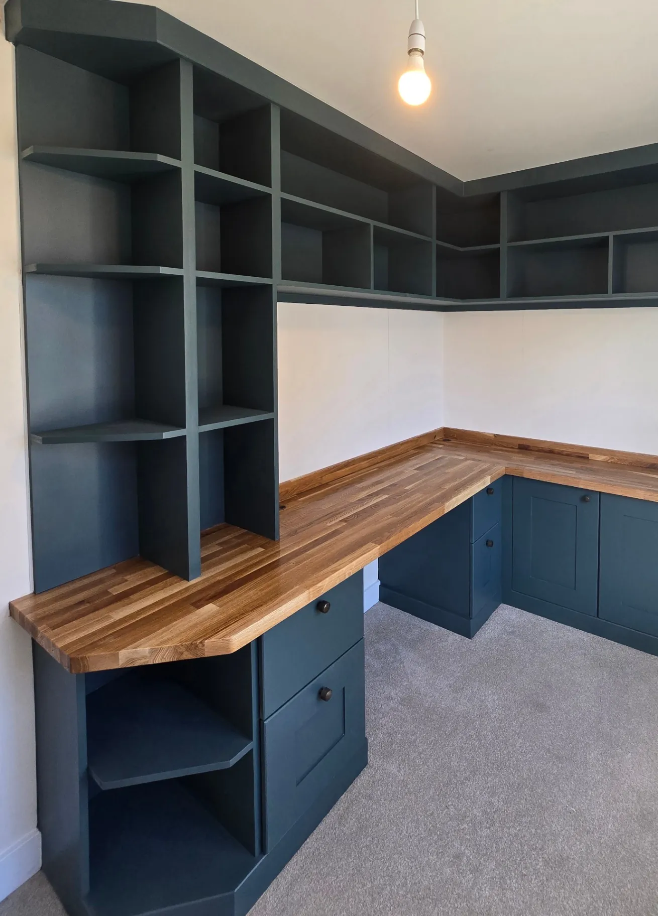 Home office corner desk with dark blue spray-painted cabinetry and a solid oak desktop in Rugby