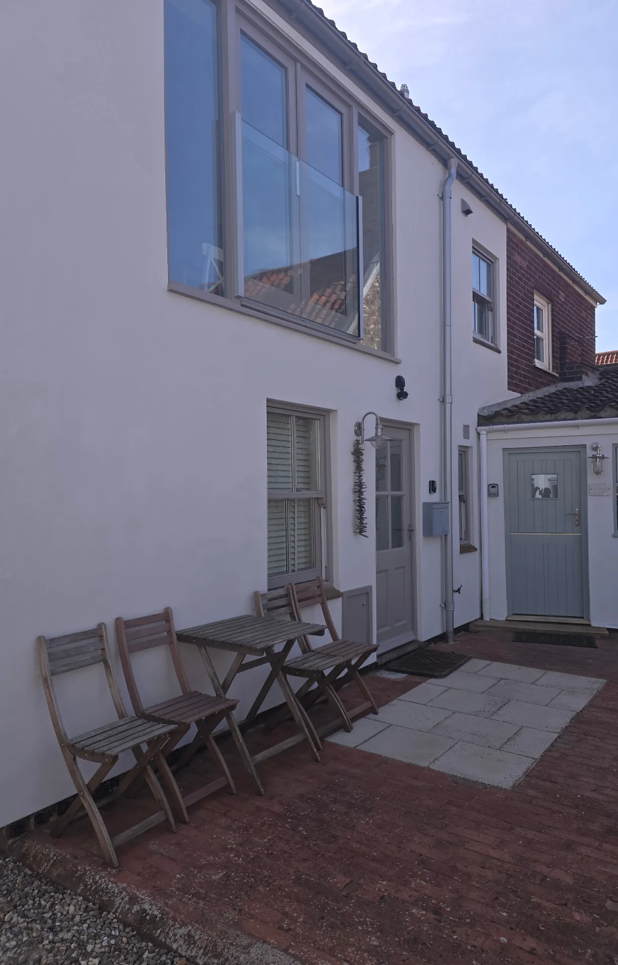 Modern home with crisp white render and uPVC windows contrast-sprayed in dark grey — Lutterworth