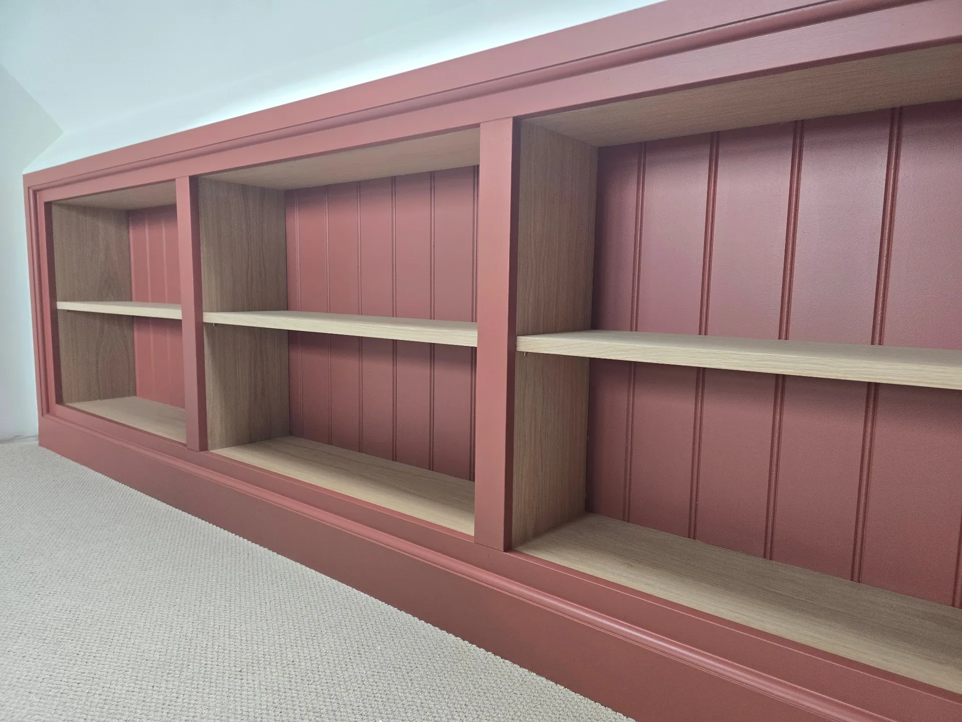 Custom-built alcove shelving unit painted in a vibrant dusty pink satin finish in Hinckley
